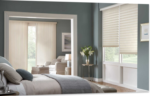 Modern bedroom with light coming in from multiple windows, each with different style white blinds