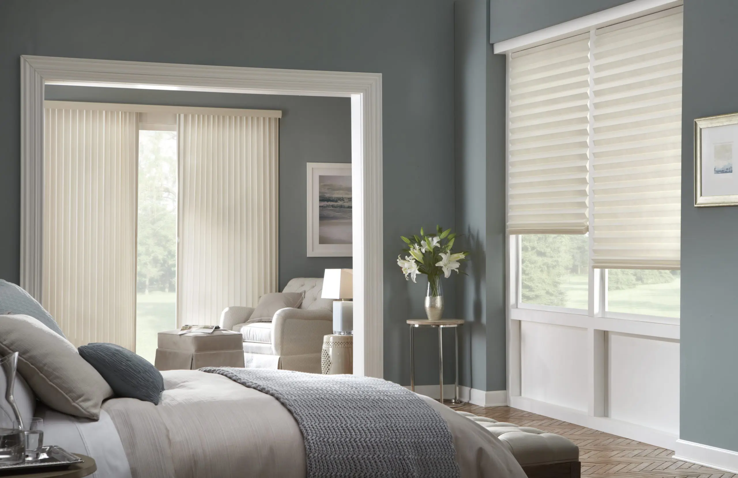 Honey comb shades over bright windows. Honey comb shades will dull the light while keeping the space bright