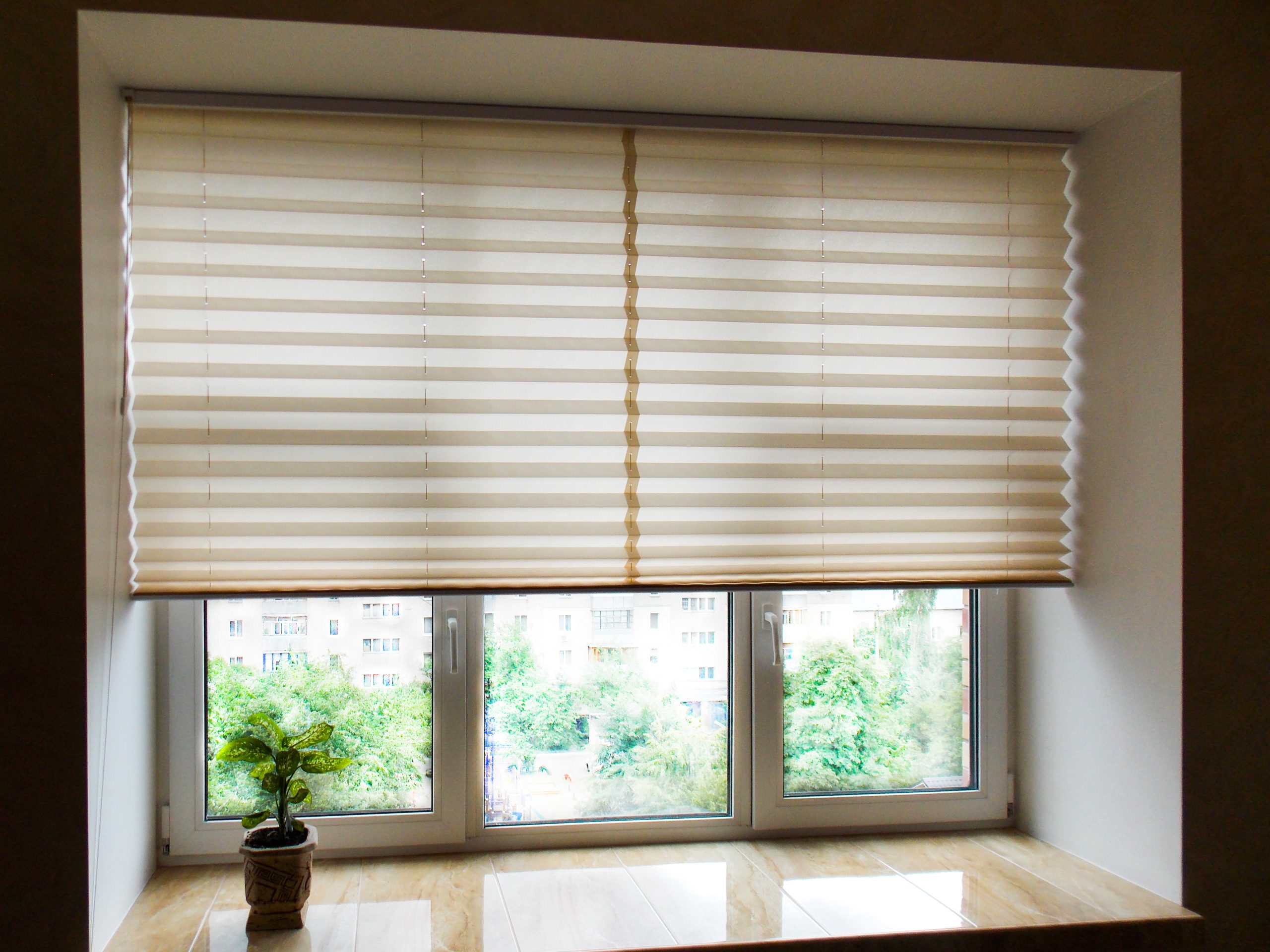 View from a window with honeycomb blinds showing how the blinds completely obstruct the view but still allow light inside